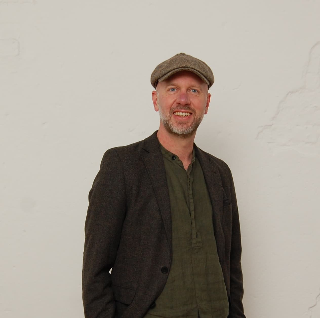 Marc Könemann in Sakko und Schiebermütze 
